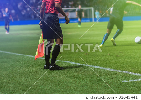 Lineman referee with flag Officiate soccer game 32045441