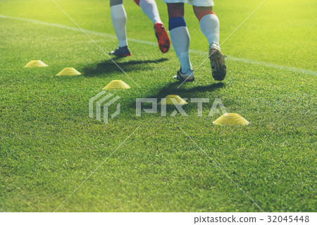 funnels on on soccer field. Soccer player practice funnels on on soccer field. Soccer player practice 32045448