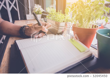 man hand write a short note on opened notebook man hand write a short note on opened notebook 32045450