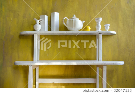 white old wooden shelf with various ceramic dishes 32047133