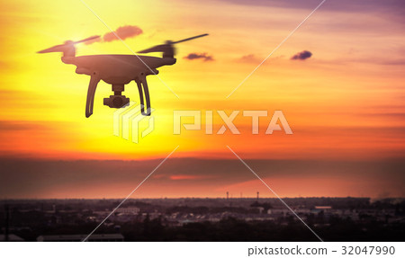 Drone in the sky at sunset. over the evening city. 32047990