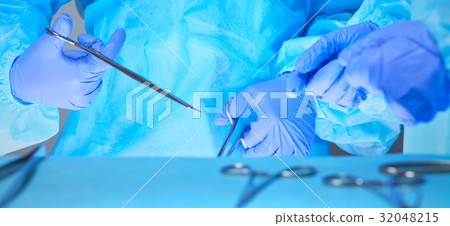 Close-up of of surgeons hands at work in operating 32048215