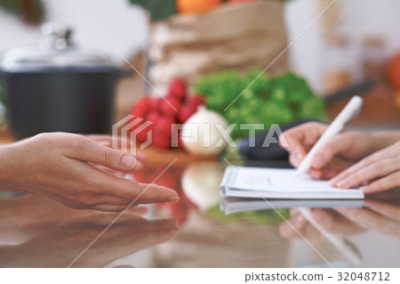 Close-up of human hands are gesticulate over a 32048712