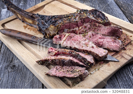 Barbecue Tomahawk Steak on Cutting Board 32048831