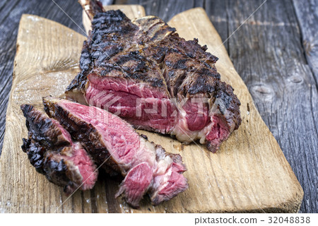Barbecue Tomahawk Steak on Cutting Board 32048838