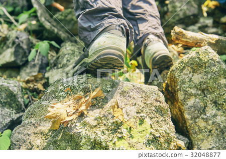Shoes of a hiker climbing up the rocky mountain Shoes of a hiker climbing up the rocky mountain 32048877