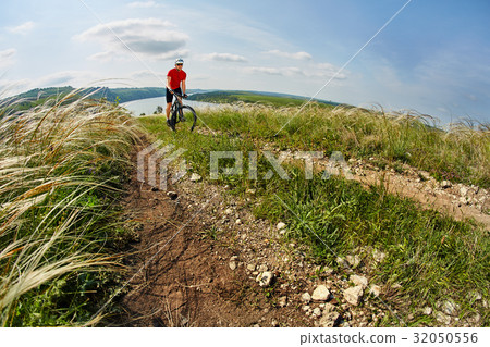 Young cyclist riding mountain bicycle through 32050556