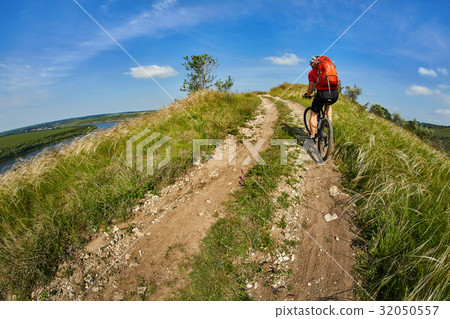 Young cyclist riding mountain bicycle through Young cyclist riding mountain bicycle through 32050557