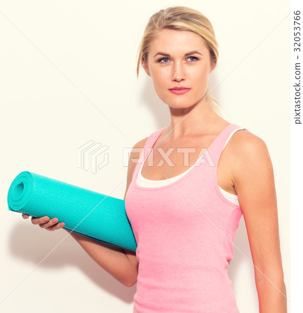 Woman holding yoga mat Woman holding yoga mat 32053766