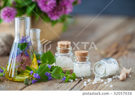 Vials of tincture, bottles of homeopathy globules. 32057038