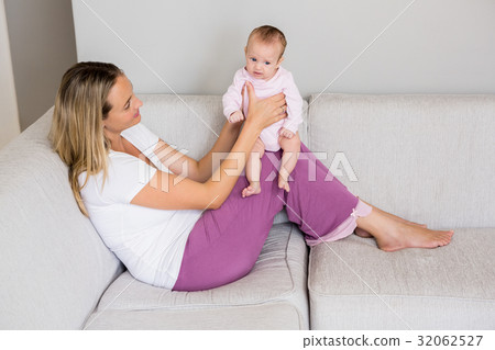 Mother playing with her baby 32062527