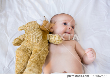 Baby lying on baby bed 32062558