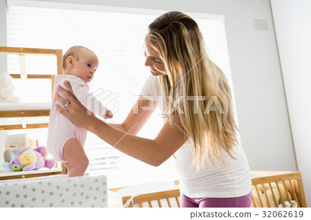 Mother playing with her baby 32062619
