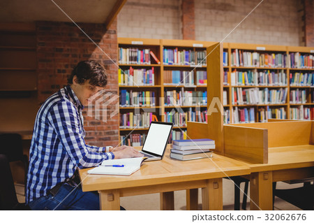 Student using laptop in library Student using laptop in library 32062676