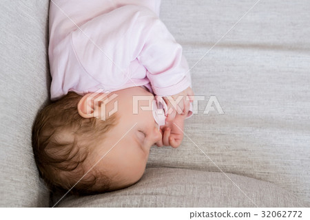 Baby sleeping with dummy in mouth 32062772