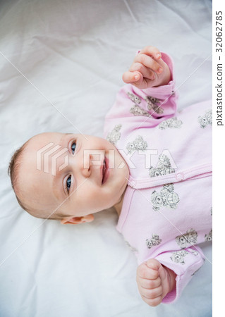 Cute baby boy relaxing on bed 32062785
