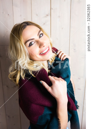 Portrait of smiling woman posing against texture background Portrait of smiling woman posing against texture background 32062865