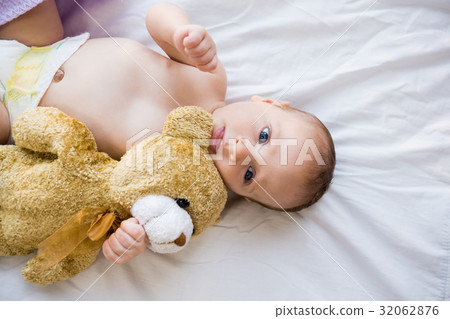 Baby lying on baby bed Baby lying on baby bed 32062876