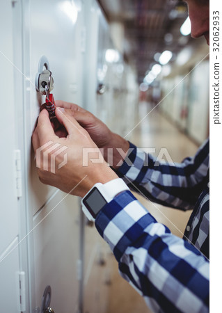 Student opening his locker 32062933