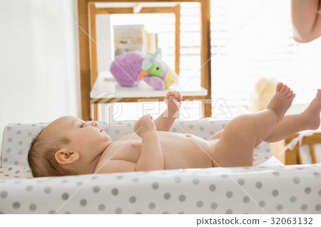 Baby lying on baby bed 32063132