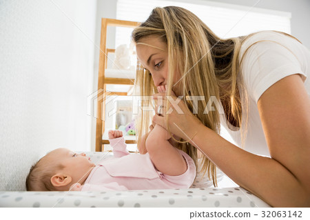 Mother playing with her baby 32063142