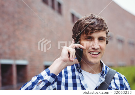 Smiling student talking on mobile phone 32063233
