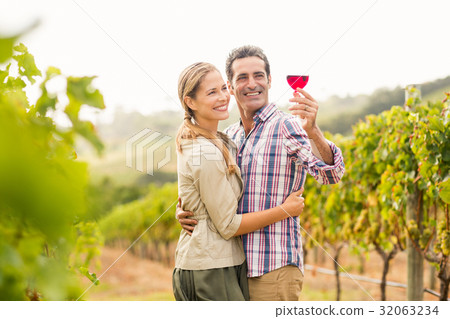 Happy couple looking at glass of wine 32063234
