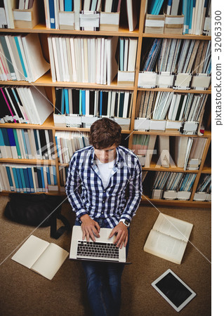 Student using laptop in library 32063300