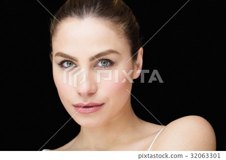 Portrait of beautiful woman posing against black background 32063301
