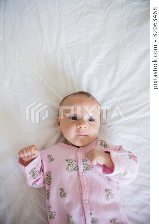 Cute baby boy relaxing on bed 32063468