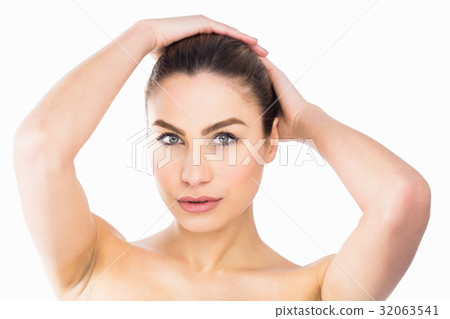 Portrait of beautiful woman posing against white background Portrait of beautiful woman posing against white background 32063541