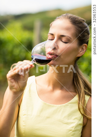 Female vintner having wine Female vintner having wine 32063553