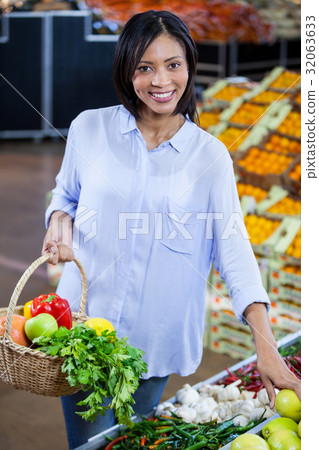 Woman buying vegetables and fruits in organic section Woman buying vegetables and fruits in organic section 32063633