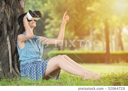beautiful asian woman touch screen with VR headset beautiful asian woman touch screen with VR headset 32064728