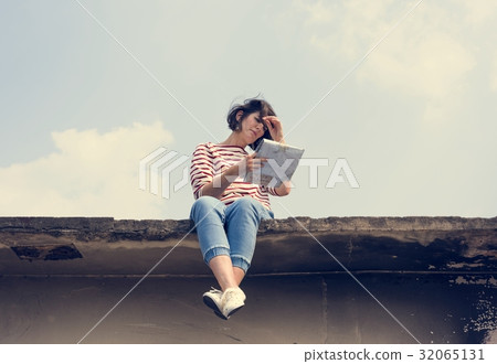 Woman sitting on deck and looking map Woman sitting on deck and looking map 32065131