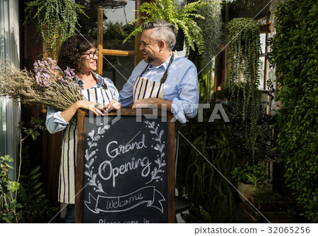 Adult Man and Woman Standing with Grand Opening Sign 32065256