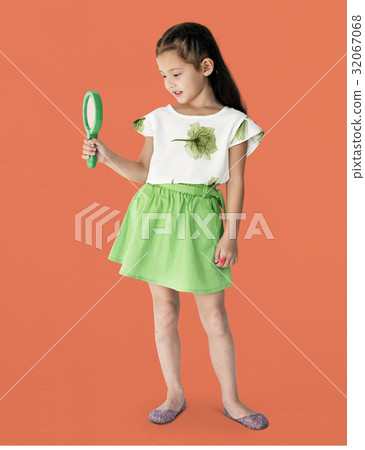 A girl is holding green magnifier A girl is holding green magnifier 32067068
