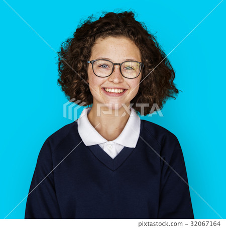 Portrait studio shoot of schoolgirl in uniform with smiling 32067164