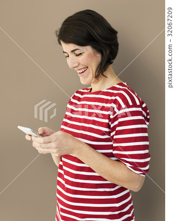 Adult Woman Using Mobile Phone Cheerfully Adult Woman Using Mobile Phone Cheerfully 32067209