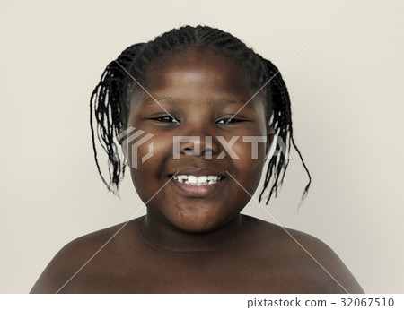 Little african girl smiling shirtless studio portrait 32067510