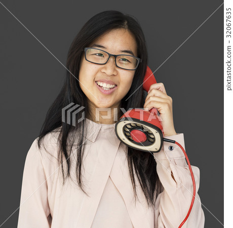 Asian girl talking by phone studio portrait Asian girl talking by phone studio portrait 32067635