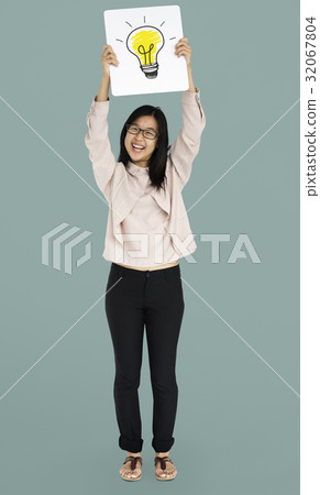 Young adult asian girl smiling and holding light bulb banner Young adult asian girl smiling and holding light bulb banner 32067804