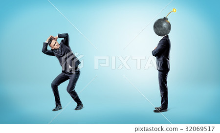 A businessman trying to hide and cover himself 32069517