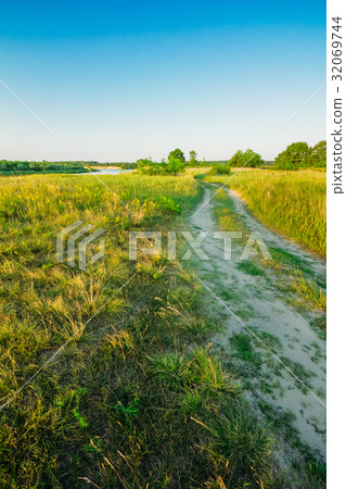 Rural road in the field. Blue sky Rural road in the field. Blue sky 32069744