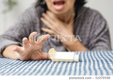 Elderly woman choking and holding an asthma spray Elderly woman choking and holding an asthma spray 32070590