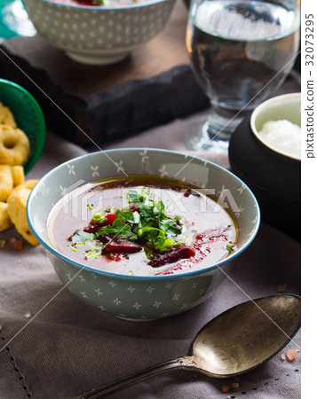 Beetroot soup served in bowls on napkin 32073295