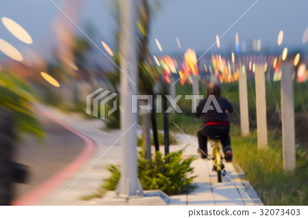 A child riding a bicycle in the evening. A child riding a bicycle in the evening. 32073403