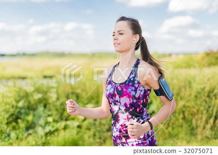 Beautiful, young woman running by the country road. Jogging conc Beautiful, young woman running by the country road. Jogging conc 32075071