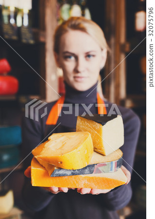 Various italian hard cheese in shop assistant Various italian hard cheese in shop assistant 32075796