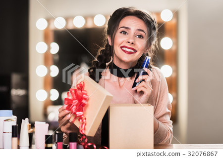 Excited girl likes cosmetology as present 32076867